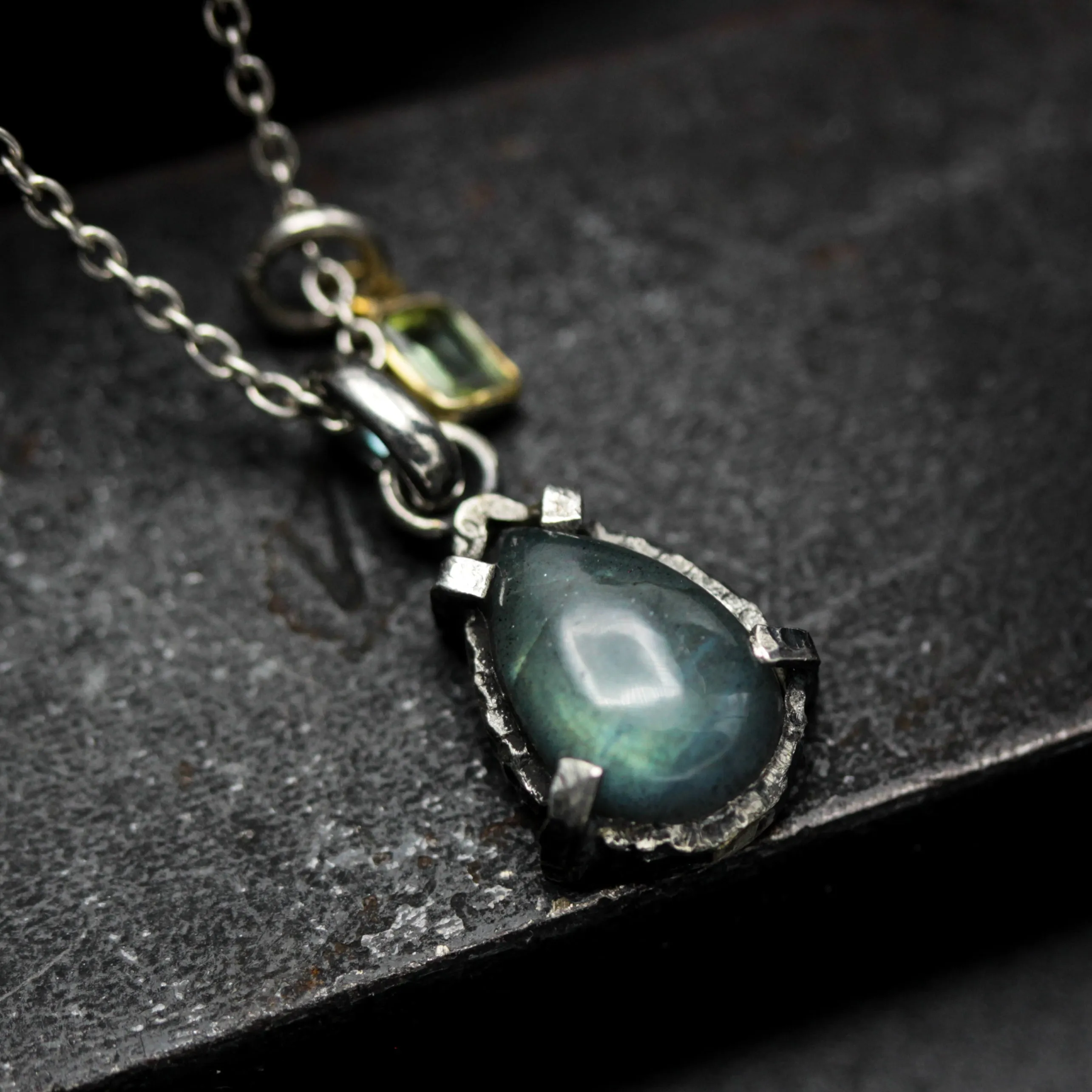 Tiny teardrop cabochon labradorite pendant necklace in silver bezel and prongs setting with green tourmaline gemstone